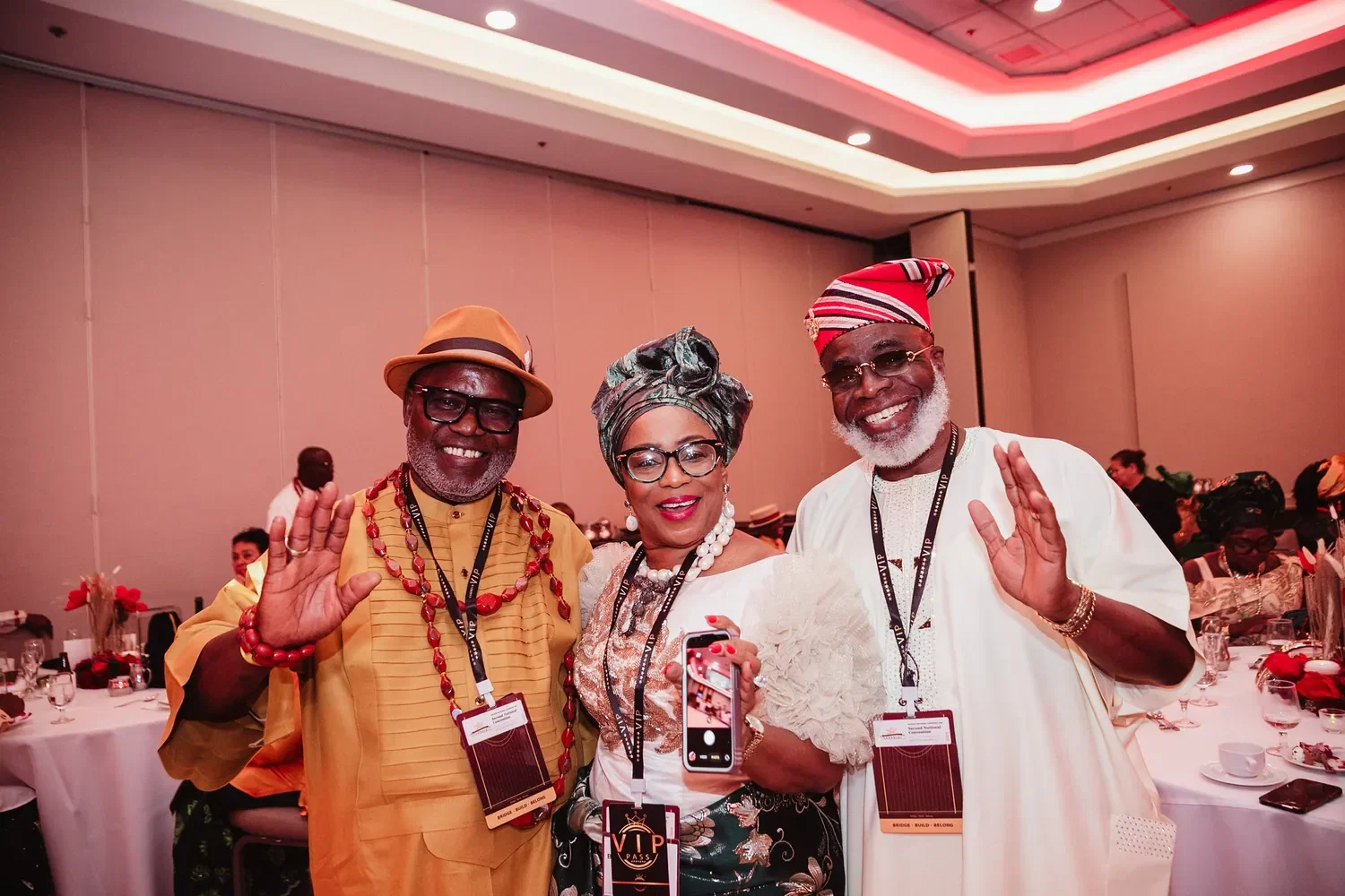 Three members waving at a Gala Night table, Convention 2026, San Francisco